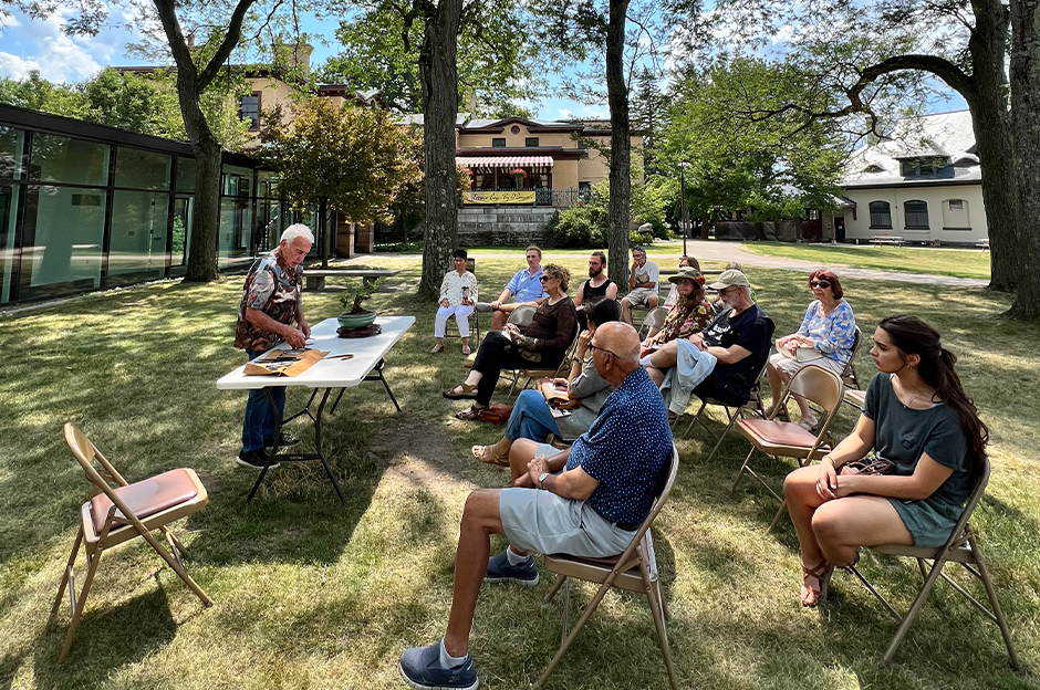 mohawk valley bonsai club outdoors demonstrating with people sitting in chairs watching