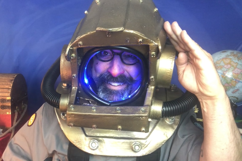 man in a scuba helmet saluting