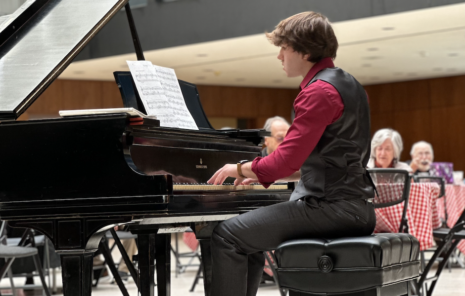 man playing piano in art gallery 