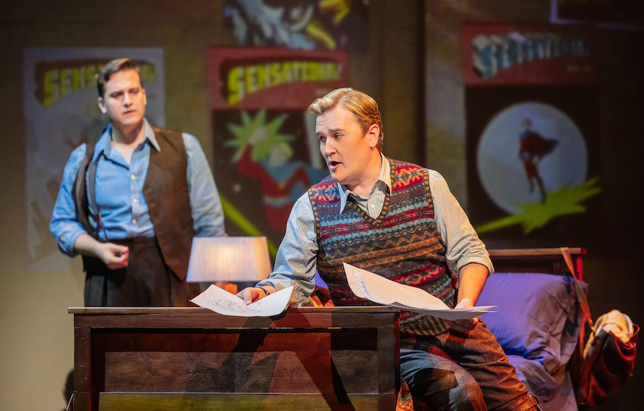 men on a stage performing an opera about a comic book being created