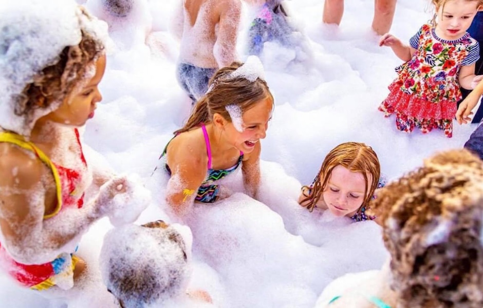 kids playing in foam outside