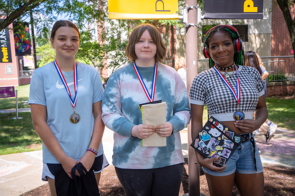 kids standing with metals around their necks