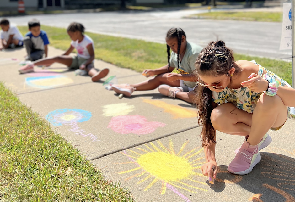 children drawing with chalk